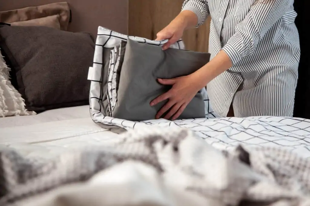 Person folding bed sheets
